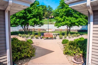 View of a landscaped outdoor seating area with trees