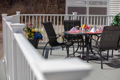 Outdoor dining area with flowers and table setup