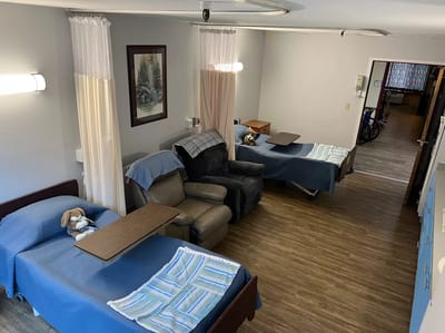 Interior view of a resident room with beds and seating