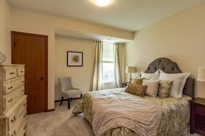 Cozy resident bedroom with a bed and chair