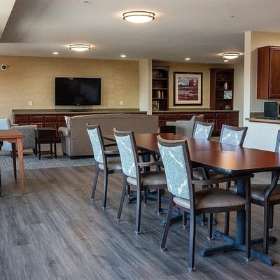 Common area with tables and seating in a senior living facility