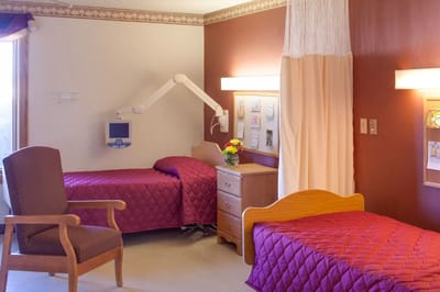 A shared resident room with two beds and decor