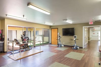 Rehabilitation room with exercise equipment and therapy area