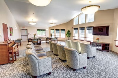 Bright common area with seating and piano