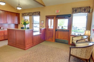 Interior view of a reception area with a desk and seating