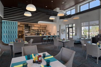 Modern dining area with tables and a coffee bar
