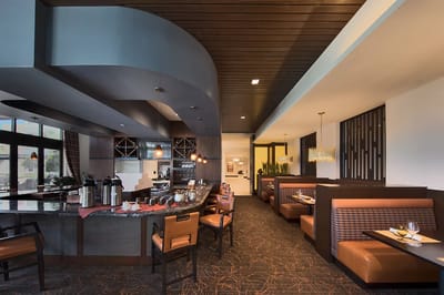 Bright dining area with booths and a coffee station