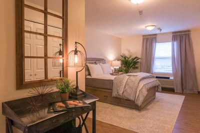 Well-decorated private resident room with a bed and decor