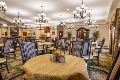 Bright dining room with elegant chandeliers and tables