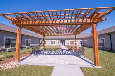 Outdoor patio area with wooden pergola