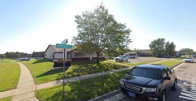 Exterior view of an assisted living facility on a sunny day
