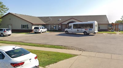 Exterior view of the facility with transport vehicles