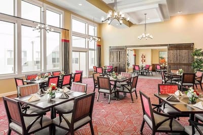 Bright dining room with tables set for meals