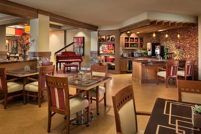 Bright dining room with piano and decorative accents