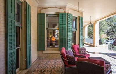Outdoor seating area with colorful shutters
