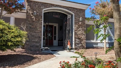 Entrance of Mother‘s Touch Senior Home with flowers and garden