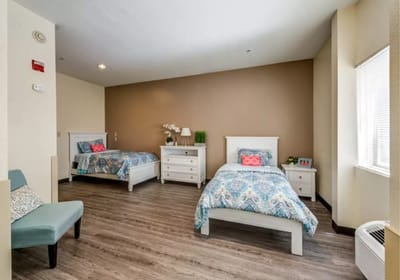 Private resident room with two beds and decor