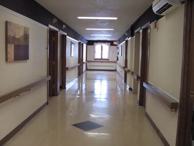 Brightly lit hallway with artwork and handrails