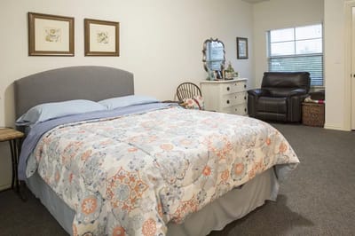 Cozy private room with a bed and chair