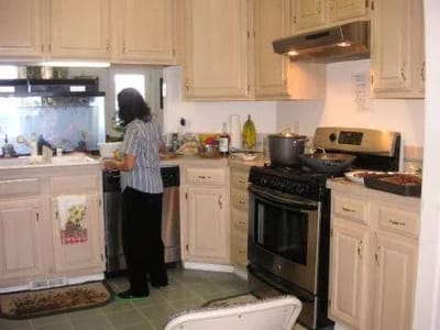 Resident cooking in a warm kitchen setting