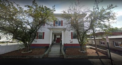 Exterior view of Myrtle Manor building with trees