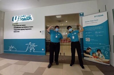 Staff members in uniforms at the facility entrance
