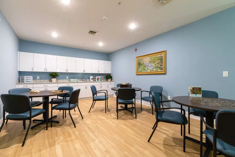Bright activity room with tables and chairs