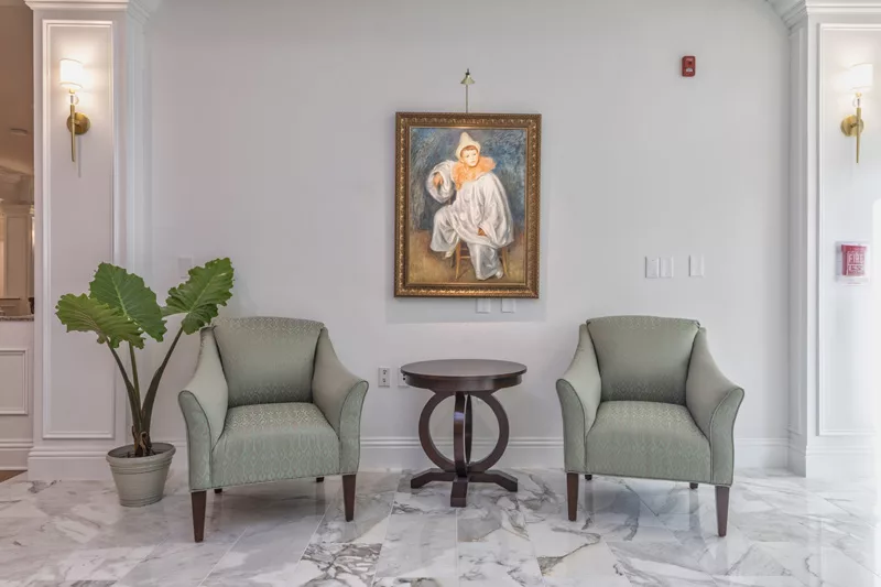 Interior space with armchairs and artwork