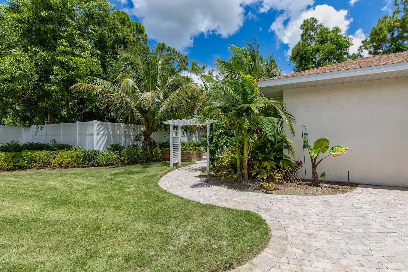 Lush garden with palm trees and pathway
