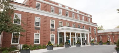 Front entrance of a senior living facility with landscaped planters