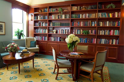 Cozy common area with bookshelves and floral decor