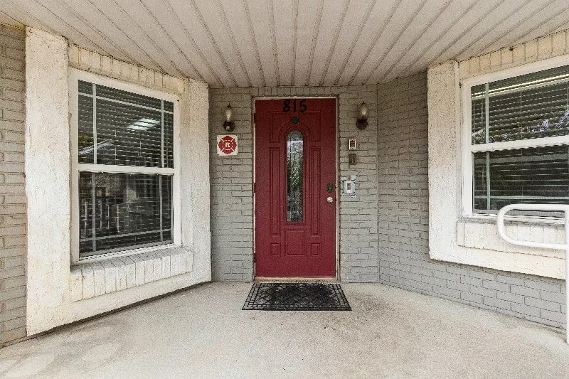 Entrance of the facility with red door and windows