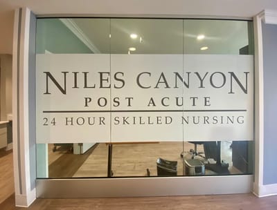 Glass entrance with facility name and services