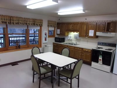A bright kitchen area with a table and chairs