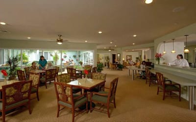 Residents in a bright common area with natural light