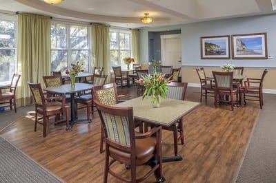 Bright dining room with tables and flowers