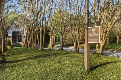 Entrance sign of Grove Park surrounded by trees
