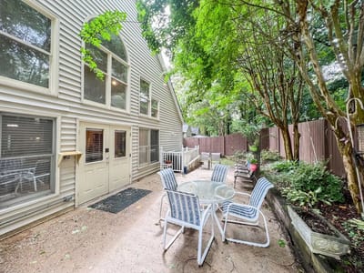 Outdoor patio area with seating and greenery