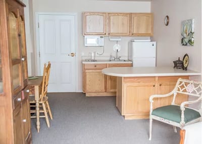 A cozy resident room with kitchen and furniture