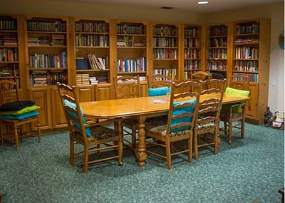 A cozy library with wooden furniture and bookshelves