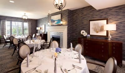 Elegant dining room setup with tables for residents