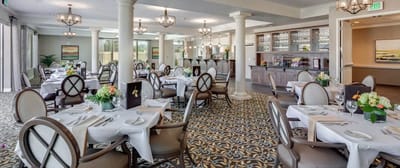 Elegant dining room setup with tables and flowers