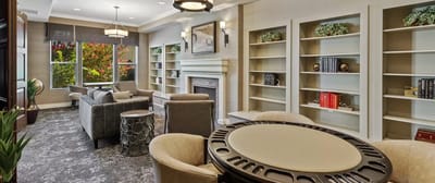 Comfortable common area with seating and bookshelves