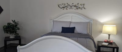 Cozy bedroom setup with a bed, lamp, and decoration