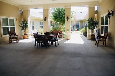 Covered outdoor seating area with tables and chairs