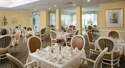 Dining area with neatly set tables and soft lighting