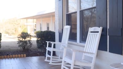 Rocking chairs on a porch at a retirement community