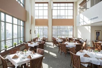 Bright dining room with tables set for a meal