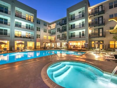 Swimming pool area with lounge chairs and hot tub