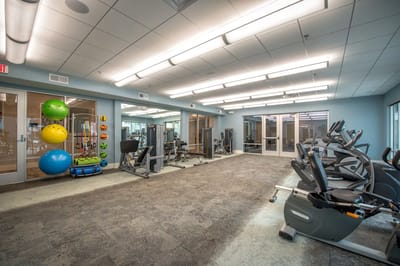 Modern fitness room with exercise equipment and color balls